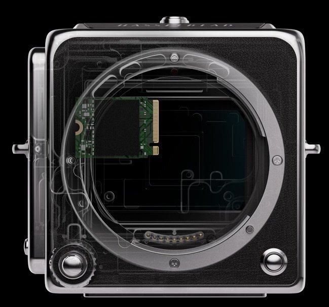 Detail of the front buttons of the Hasselblad 907X. The shutter button is at bottom left, surrounded by the aperture dial. The button at bottom right is the lens release. (Image via Hasselblad)
