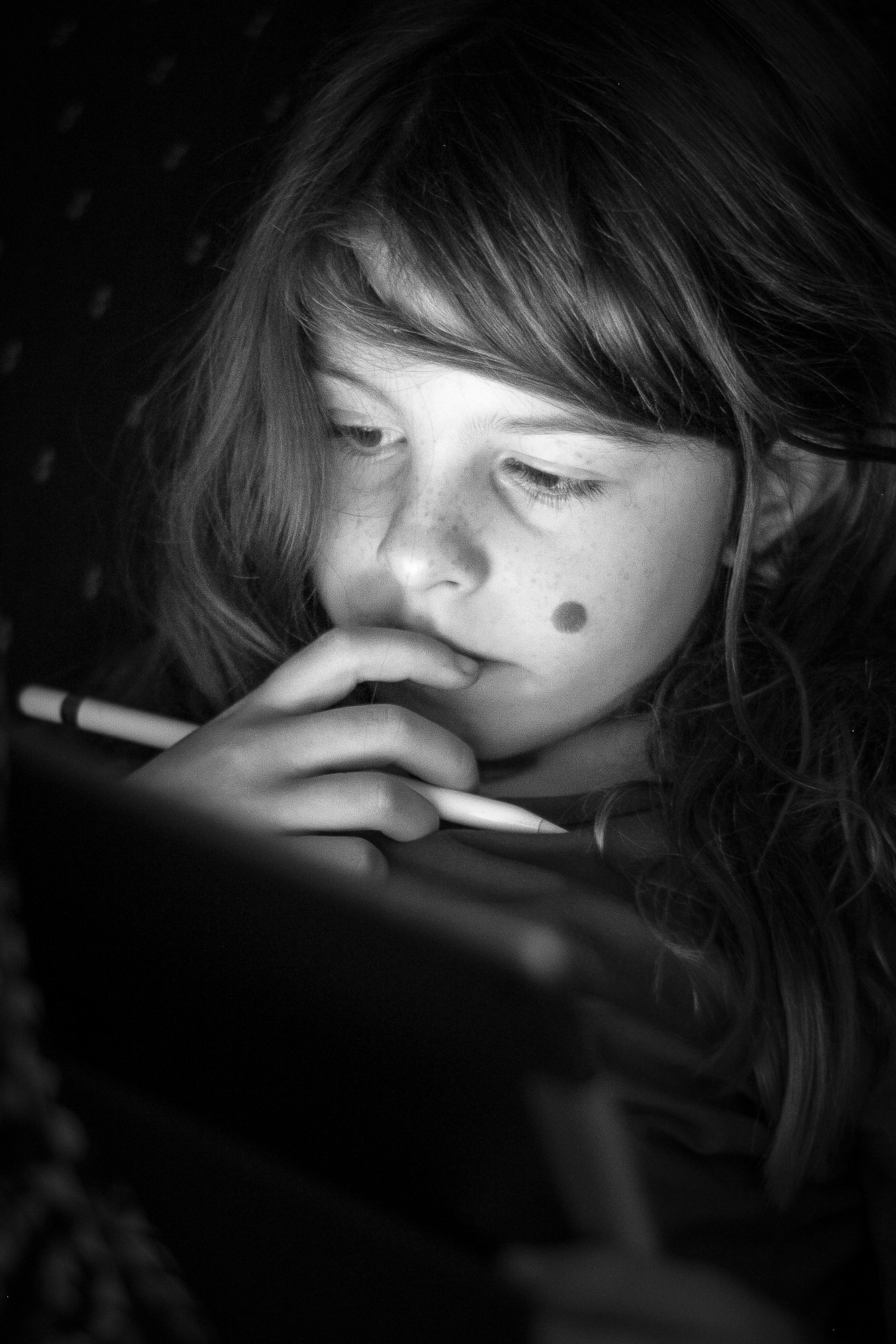 An example of using environmental light (the iPad screen) to illuminate a subject in a dark environment.  Camera: Fujifilm X-T1 Shutter speed: 1/60 second Aperture: f/1.8 ISO: 800 Photo: Jeff Carlson